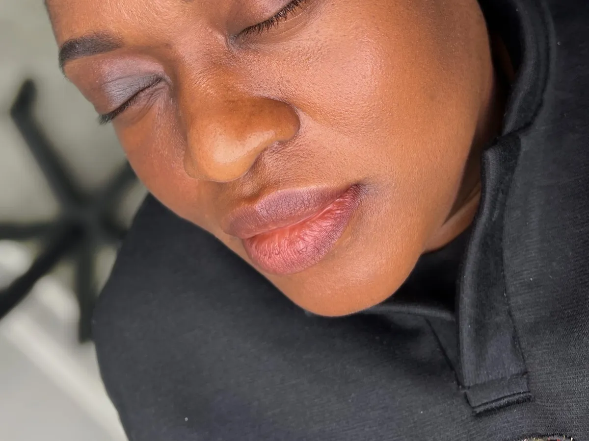 A client with freshly done brows, eyes closed